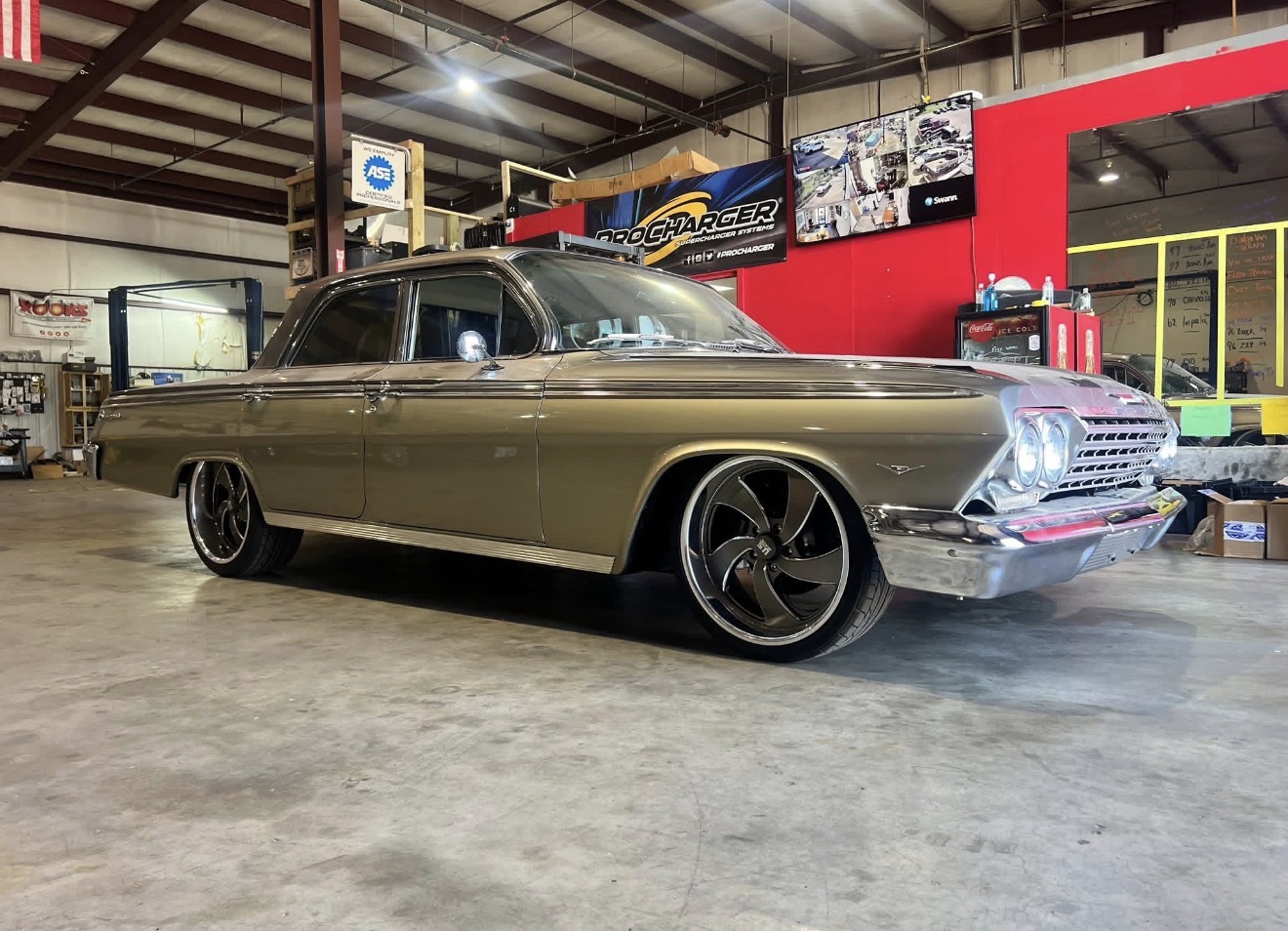 1962 Chevrolet Impala restomod on billet wheels inside the shop